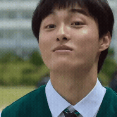 A Young Man Wearing A Green Vest And Tie Looks Up At Something GIF