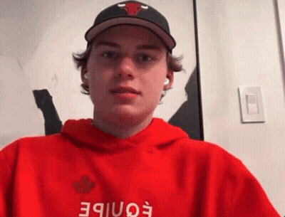 A Young Man Wearing A Hat And A Red Hoodie With The Word Eonibe On It GIF