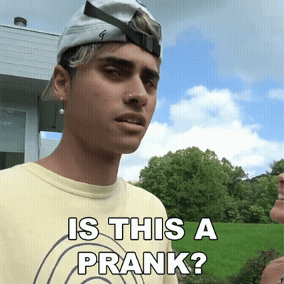 A Young Man Wearing A Hat And A Yellow Shirt Says Is This A Prank GIF