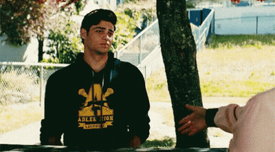 A Young Man Wearing A Hoodie That Says Adler High Is Shaking Hands With Another Person . GIF