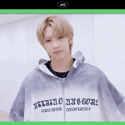 A Young Man Wearing A Hoodie That Says Id12 Holds A Red Rose In His Hand GIF