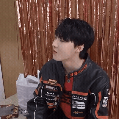 A Young Man Wearing A Jacket That Says Formula 1 On It GIF