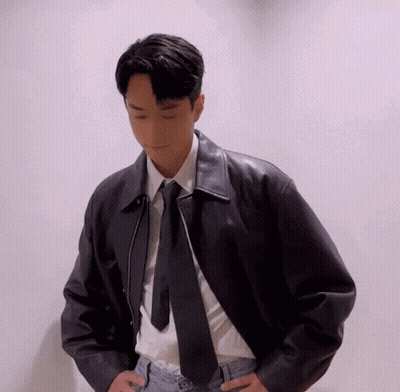 A Young Man Wearing A Leather Jacket And Tie GIF