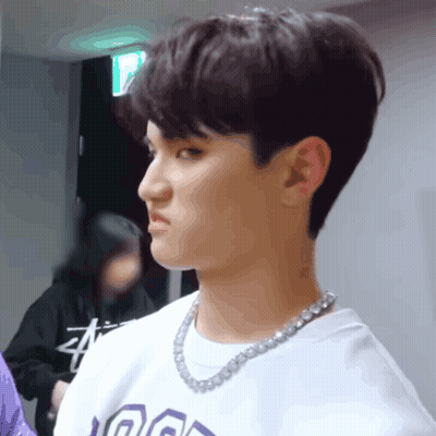 A Young Man Wearing A Necklace And A T-Shirt That Says ' A ' On It GIF