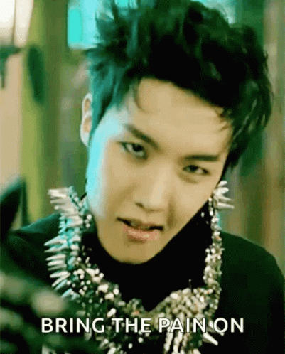 A Young Man Wearing A Necklace With Spikes And The Words Bring The Pain On Behind Him GIF