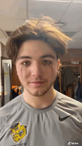 A Young Man Wearing A Nike Shirt Has Tears Running Down His Face GIF