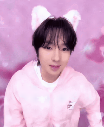 A Young Man Wearing A Pink Hoodie With A Panda On It GIF