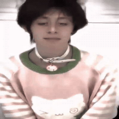 A Young Man Wearing A Pink Sweater With A Cat On It And A Choker . GIF