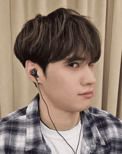A Young Man Wearing A Plaid Shirt And Headphones GIF
