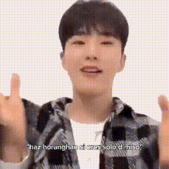 A Young Man Wearing A Plaid Shirt Is Giving A Thumbs Up . GIF
