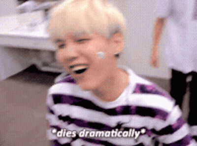 A Young Man Wearing A Purple And White Striped Shirt Is Laughing And Says `` Dies Dramatically '' . GIF