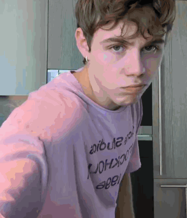 A Young Man Wearing A Purple T-Shirt That Says ' Aruba ' On It GIF