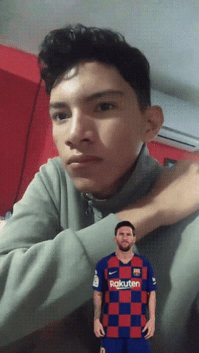 A Young Man Wearing A Rakuten Shirt Looks At The Camera GIF