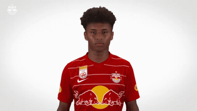 A Young Man Wearing A Red Bull Jersey Is Making A Gesture With His Hands GIF