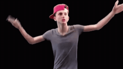 A Young Man Wearing A Red Hat And A Gray Shirt Is Dancing . GIF