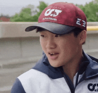 A Young Man Wearing A Red Hat That Says Cj On It GIF