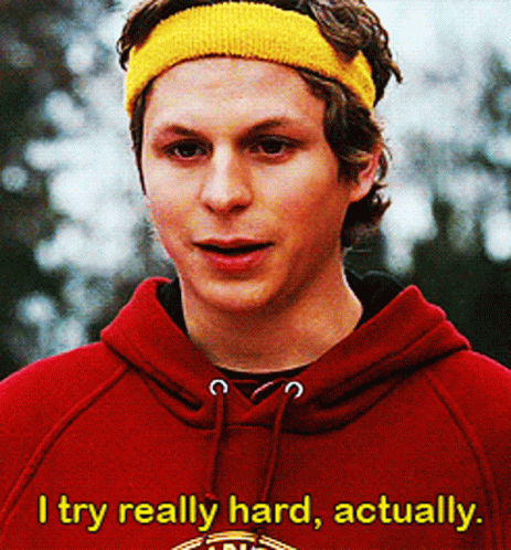 A Young Man Wearing A Red Hoodie And A Yellow Headband Says " I Try Really Hard Actually " GIF