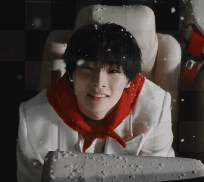 A Young Man Wearing A Red Scarf Is Sitting In A Car Seat GIF