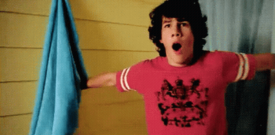 A Young Man Wearing A Red T-Shirt With A Picture Of A Person On It GIF