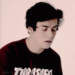 A Young Man Wearing A Red Thrasher Skateboard Magazine T-Shirt GIF