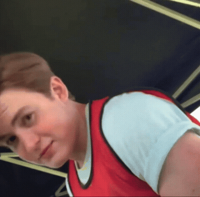 A Young Man Wearing A Red Vest And White Shirt GIF
