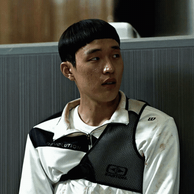 A Young Man Wearing A Revolution Jacket Sits In A Cubicle GIF