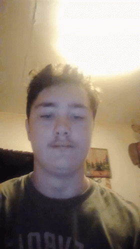 A Young Man Wearing A Shirt That Says Always Looks At The Camera GIF