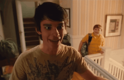 A Young Man Wearing A Shirt That Says ' Rock ' On It Smiles GIF
