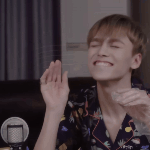 A Young Man Wearing A Shirt That Says Uljay Is Smiling With His Eyes Closed GIF
