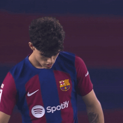 A Young Man Wearing A Spotify Shirt Is Looking At The Camera GIF