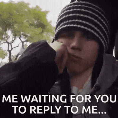 A Young Man Wearing A Striped Hat Is Waiting For A Reply GIF
