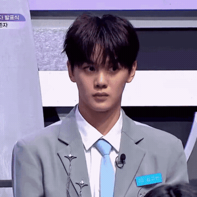 A Young Man Wearing A Suit And Tie With A Name Tag That Says ' Hyun ' On It GIF