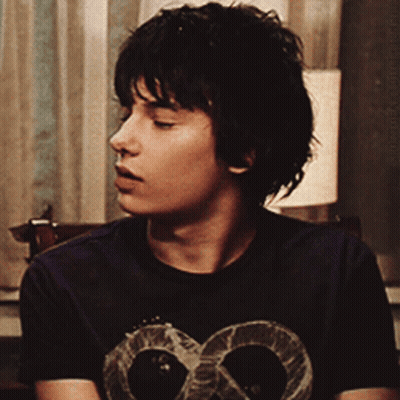 A Young Man Wearing A T-Shirt With A Skull On It GIF