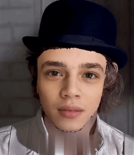 A Young Man Wearing A Top Hat With A Drawing Of His Face On It GIF