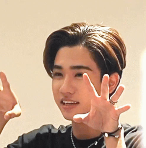 A Young Man Wearing A Watch And A Necklace Is Making A Funny Face GIF