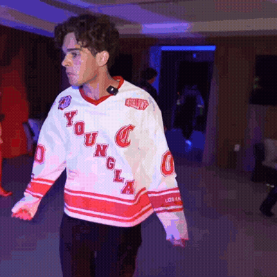 A Young Man Wearing A White And Red Jersey With The Word Young On It GIF