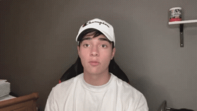 A Young Man Wearing A White Champion Hat GIF