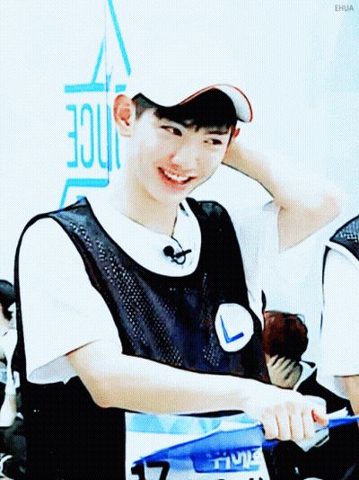 A Young Man Wearing A White Hat And A Black Vest Is Smiling GIF
