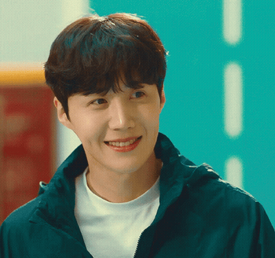 A Young Man Wearing A White Shirt And A Green Jacket Smiles For The Camera GIF