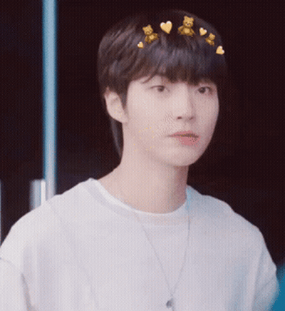 A Young Man Wearing A White Shirt And A Necklace With Teddy Bears On His Hair . GIF