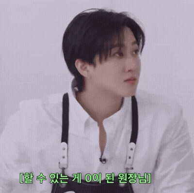 A Young Man Wearing A White Shirt And Black Suspenders Is Looking At Something GIF