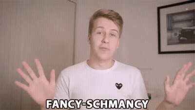 A Young Man Wearing A White Shirt With A Black Heart On It Says Fancy-Schmancy GIF