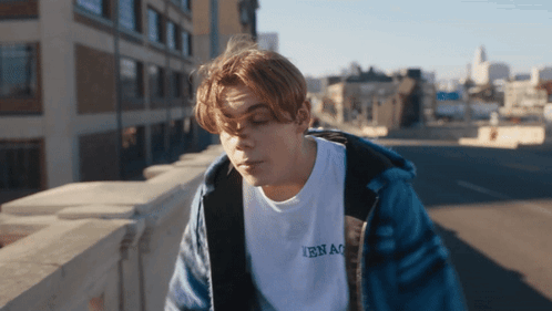A Young Man Wearing A White T-Shirt That Says Ibnao GIF