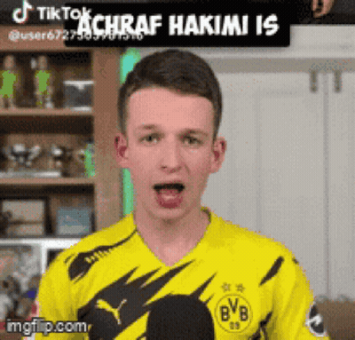 A Young Man Wearing A Yellow Bvb Jersey GIF