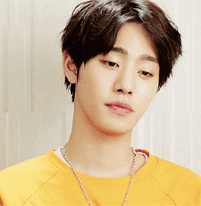 A Young Man Wearing A Yellow Shirt And A Necklace GIF