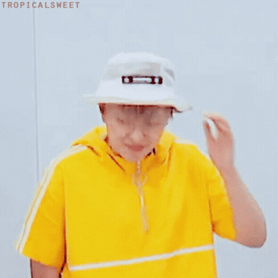 A Young Man Wearing A Yellow Shirt And A White Hat . GIF