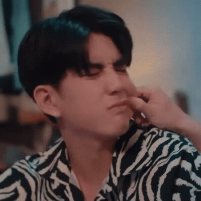 A Young Man Wearing A Zebra Print Shirt Is Holding His Nose . GIF