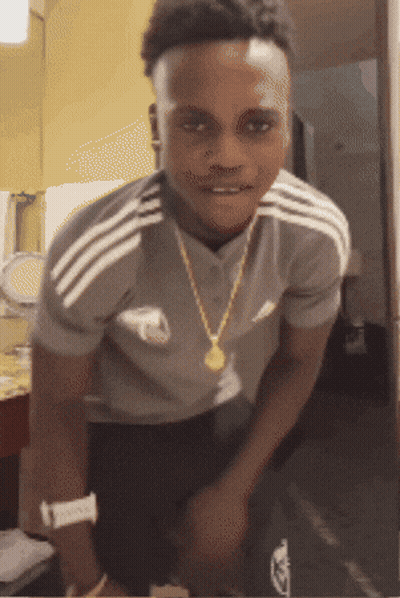 A Young Man Wearing An Adidas Shirt And A Gold Chain GIF