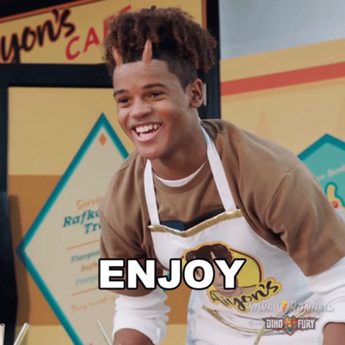 A Young Man Wearing An Apron That Says Enjoy On It GIF