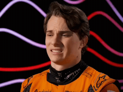 A Young Man Wearing An Orange Shirt With The Word Monster On The Collar GIF
